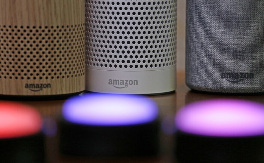 Amazon Echo and Echo Plus devices behind illuminated Echo Button devices during an event by the company in Seattle in September 2017.