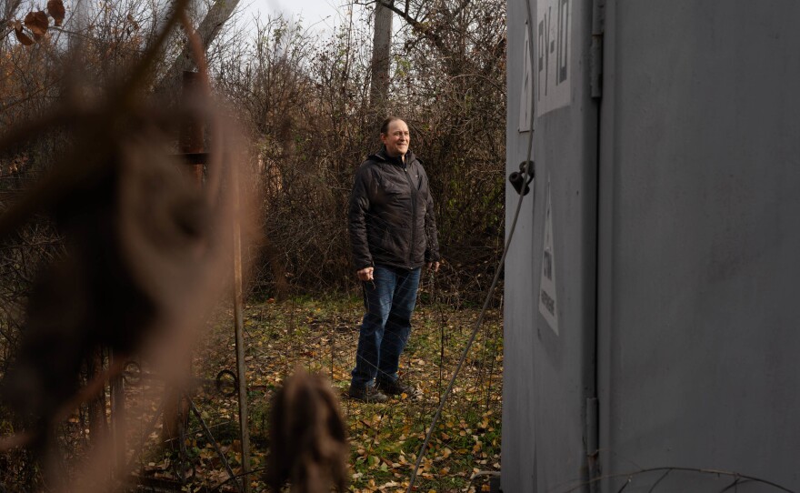 Mykhailo Voinov, an electrician who's been fixing damaged Ukrainian energy infrastructure, looks at a damaged electrical substation in northeast Ukraine's Kharkiv region.