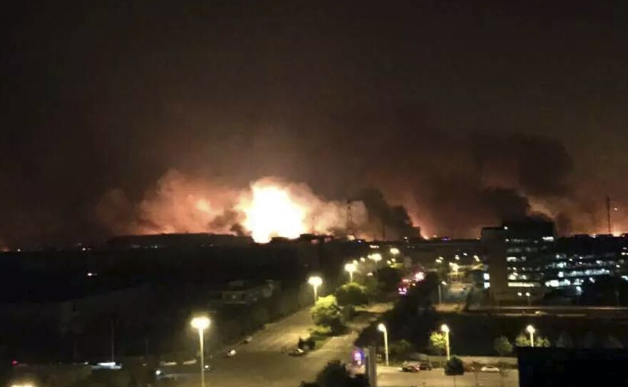 In this photo released by Xinhua News Agency smoke and fire erupt into the night sky after an explosion in north China's Tianjin Municipality early Thursday Aug. 13 local time.