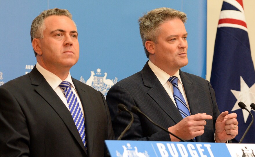 Australia's Finance Minister Mathias Cormann, right,  speaks at a news conference as Treasurer Joe Hockey looks on in Canberra on Tuesday.