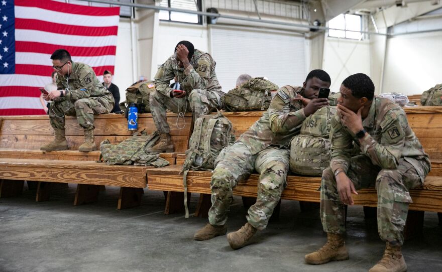 U.S. service members wait at the Pope Army Airfield before deploying to Europe at Fort Bragg, N.C. on Feb. 3.