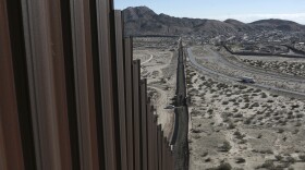 A truck drives near the Mexico-US border fence, on the Mexican side, separating the towns of Anapra, Mexico and Sunland Park, New Mexico, Wednesday, Jan. 25, 2017. 