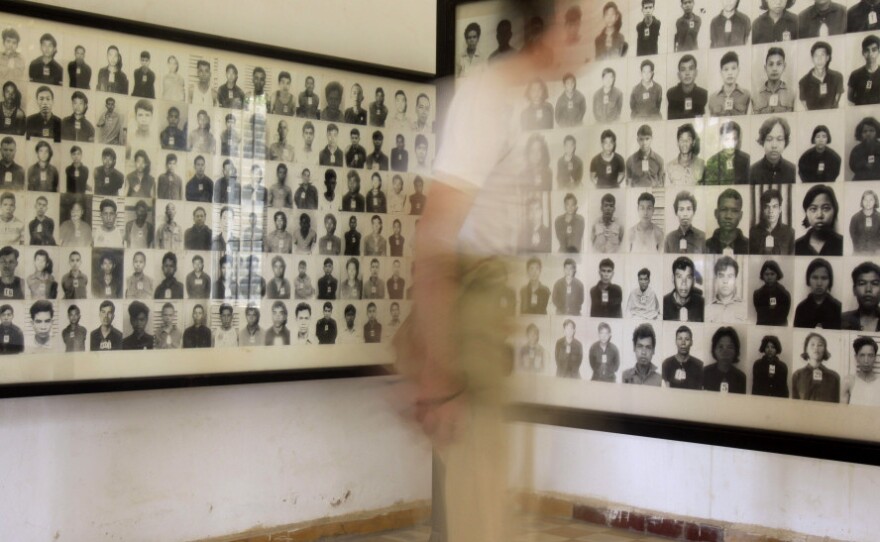 <p>A tourist views photos of former Khmer Rouge prisoners at the Tuol Sleng genocide museum, formerly the regime's notorious S-21 prison, in Phnom Penh, Cambodia, in a photo from 2009. </p>