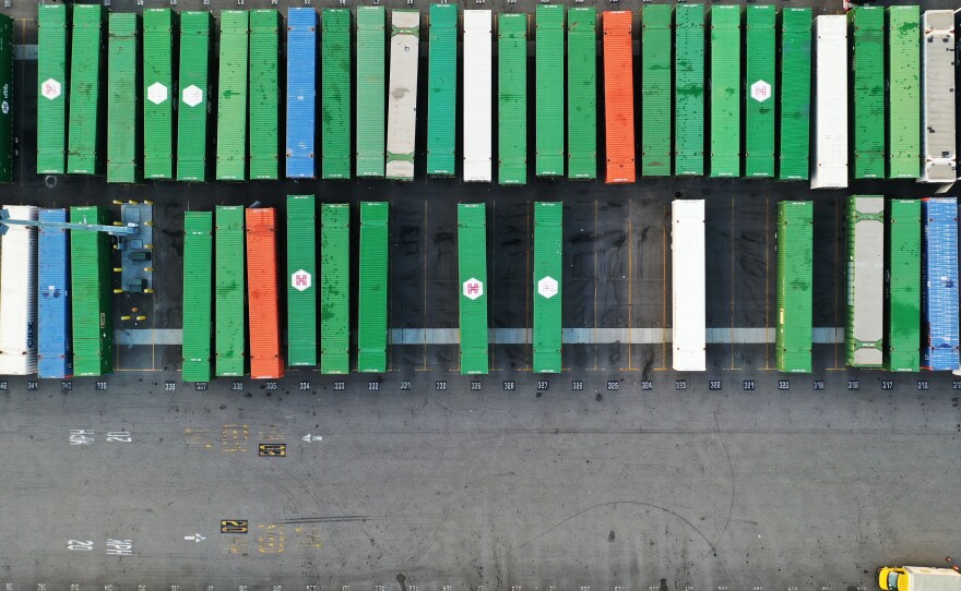 In an aerial view, shipping containers sit on truck transport chassis in a rail yard in Los Angeles on Oct. 22. Investors worry about the potential impact from omicron on already strained global supply chains.