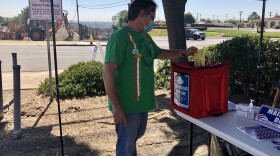 Thomas Scholey drops off his ballot at an official box at Paradise Hills Library in this file photo taken Oct. 12, 2020.