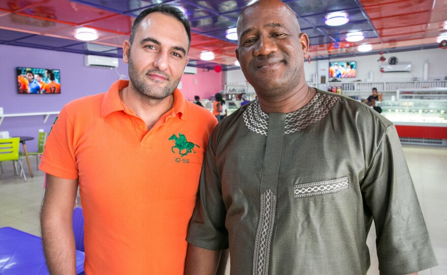 Mohamed Skaiki from Lebanon (in orange shirt) is the owner of Nice Cream — although he's brought in a Liberian partner, Ansu Kanneh.