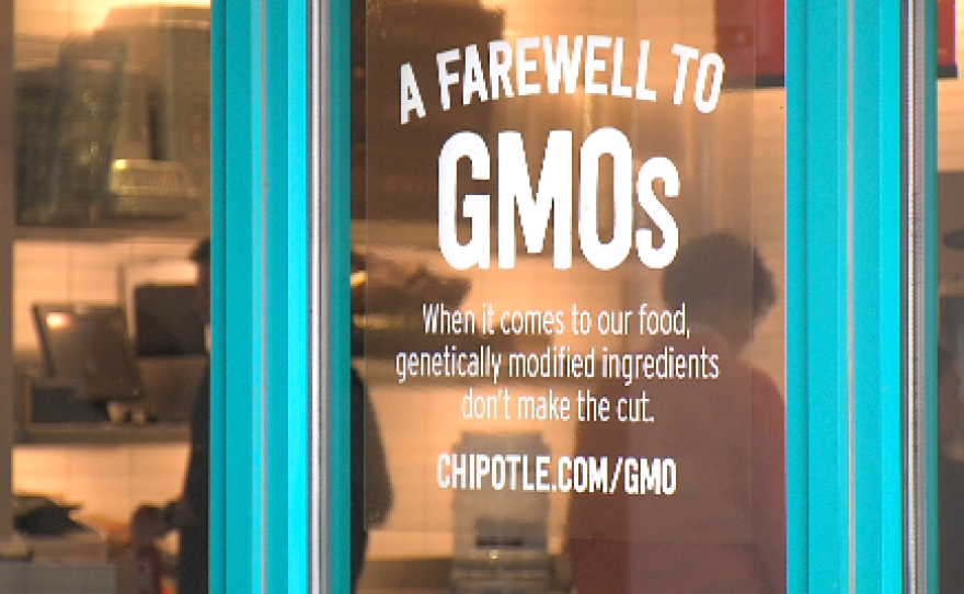 New signs at Chipotle advertise the burrito chain's decision to take GMOs off the menu, May 29, 2015.  