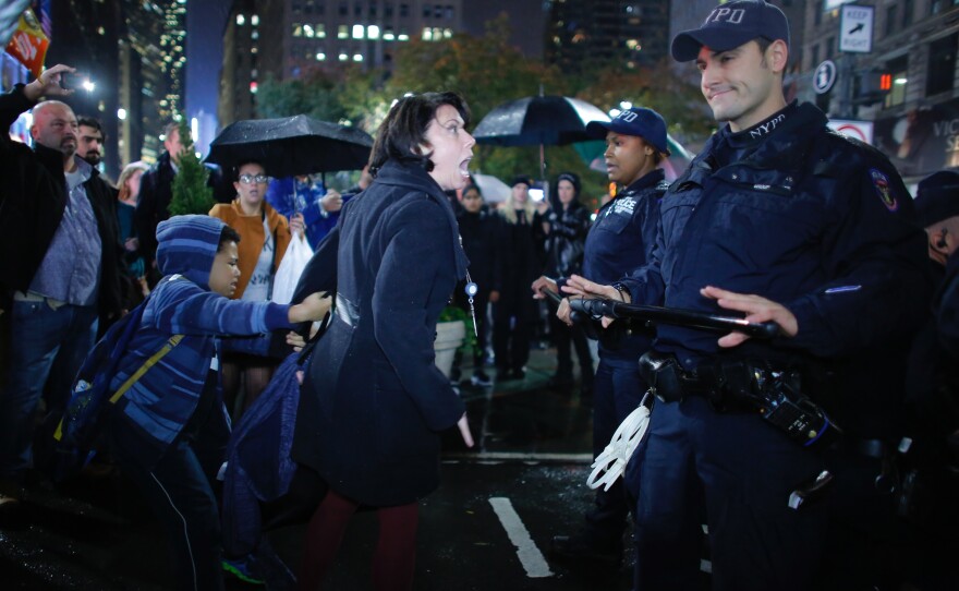 A woman argues with NYPD officers at a protest against President-elect Donald Trump in New York City on Wednesday night.