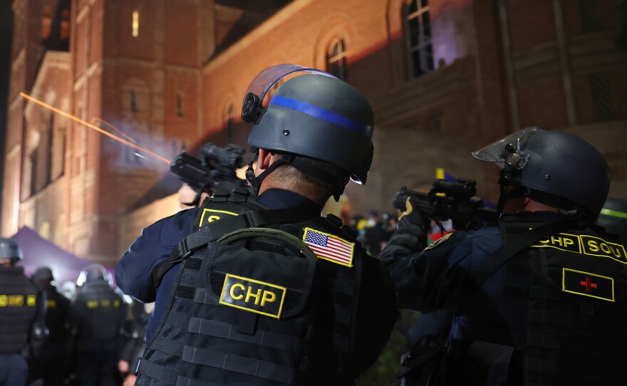 A California Highway Patrol (CHP) officer fires a flash-bang while clearing a pro-Palestinian encampment after dispersal orders were given at the University of California, Los Angeles (UCLA) campus, on May 2, 2024 in Los Angeles, California.