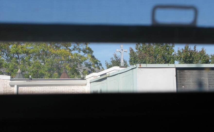 The steeple of the church next door can be seen through an upstairs window in Cassandra's house.