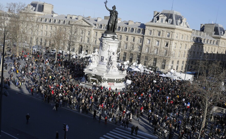 People begin gathering at Republique square before the demonstration in Paris in support of the victims of last week's violent attacks and the ideals of free speech.