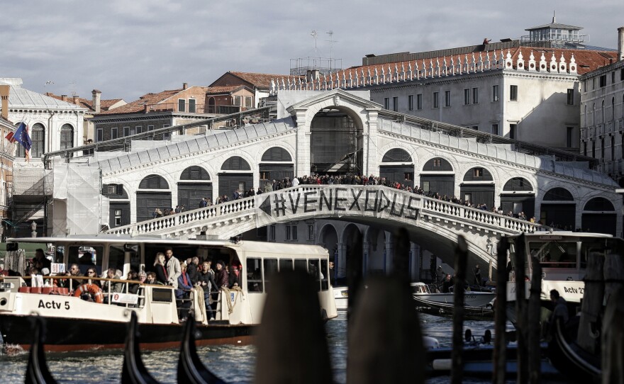 People gather on the Rialto Bridge to protest on Nov. 12 against the increasing number of tourists in Venice.