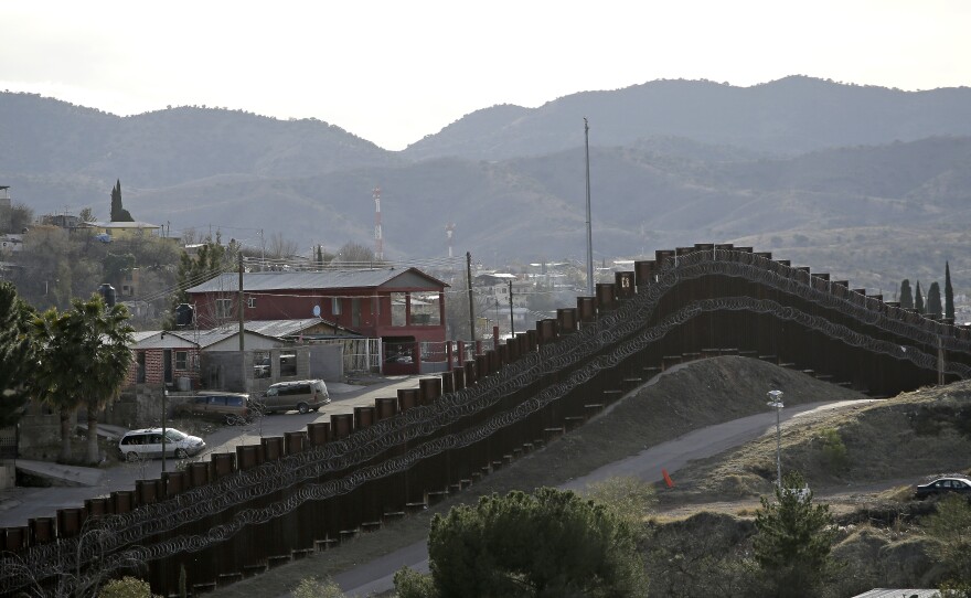 The president declared a national emergency in February to access federal money to build a wall similar to this razor-wire-covered border wall separating Nogalas, Mexico (left), and Nogales, Ariz. Congress did not approve the full amount he asked for last year to follow through on a key campaign pledge.
