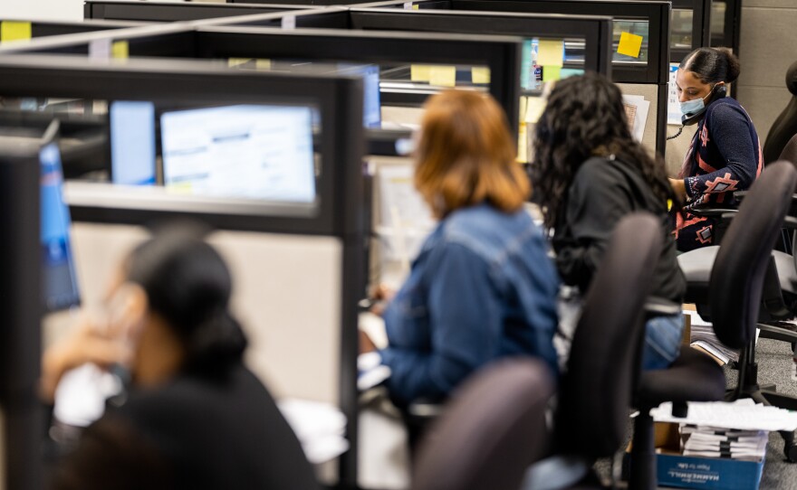 Workers answer questions in the call center at the Harris County Elections Office in Houston. In Harris County, 40% of mail-in ballot applications were flagged for rejection.