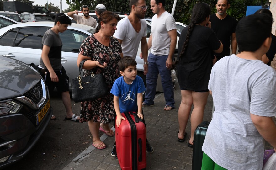 A family of survivors is taken by volunteer drivers from their home.
