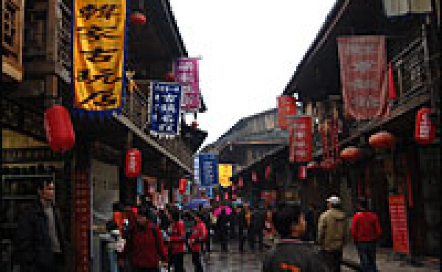 On Shangli's bustling pedestrian commercial strip, tourists can buy all sorts of souvenirs and trinkets, from cowboy hats to toy pianos.