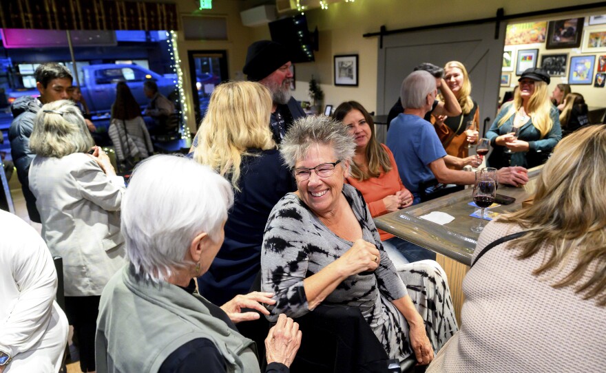 Sandy Miller speaks with Nic's Deli & Wine Bar owner Nikki Jones, left, Wednesday, Oct. 25, 2023, in Paradise, Calif. Jones lost two businesses in 2018's Camp Fire.