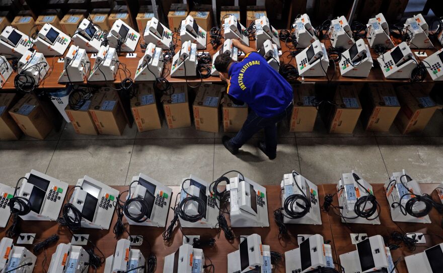 A Brazilian election official reviews electronic ballot boxes ahead of the second round of the presidential election next October 30 in Curitiba, Brazil, on Oct. 18, 2022.