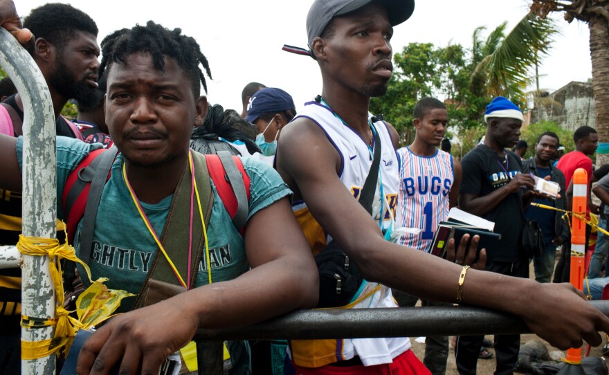 Haitian migrants wait in Necoclí for their turn to buy tickets for a boat to the town of Acandí, where they will start hiking through the Darién jungle.