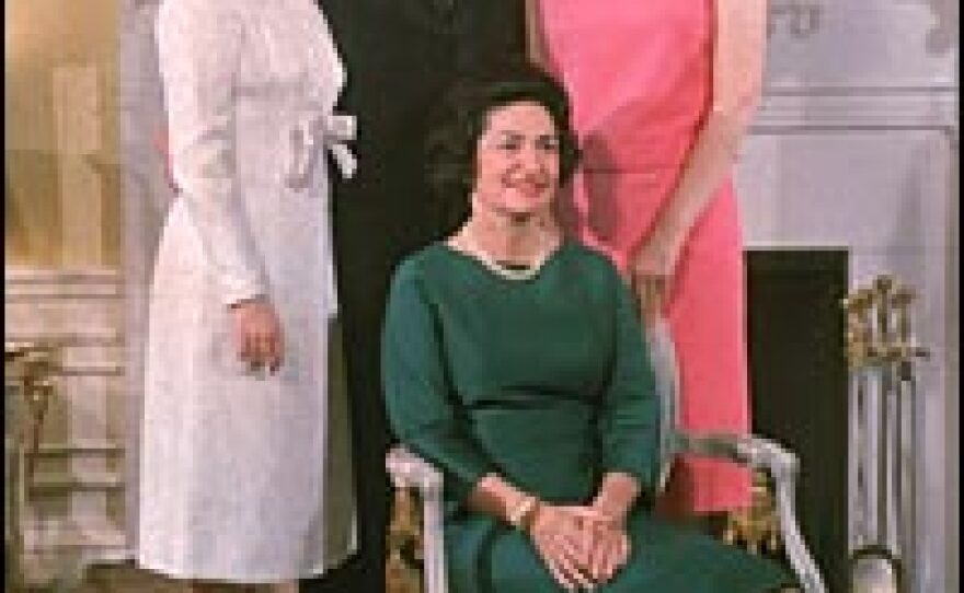 Lyndon and Lady Bird Johnson pose with their daughters, Luci Baines and Lynda Bird, in front of the fireplace at the White House, circa 1966.