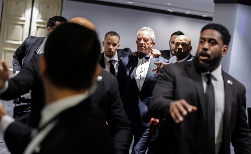 Health and Human Services Secretary Robert F. Kennedy Jr. and his wife, Cheryl Hines, are evacuated from the annual White House Correspondents' Association Dinner in Washington on Saturday.