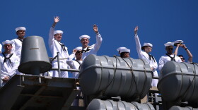 Sailors wave aboard the USS Abraham Lincoln aircraft carrier as it returns to Naval Air Station North Island after deployment Thursday, Oct. 8, 2026, in Coronado, Calif.