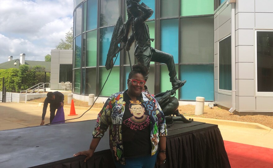 Artist Michelle Browder in front of a sculpture called <em>Blank Slate</em> by the Ghanaian artist Kwame Akoto-Bamfo.