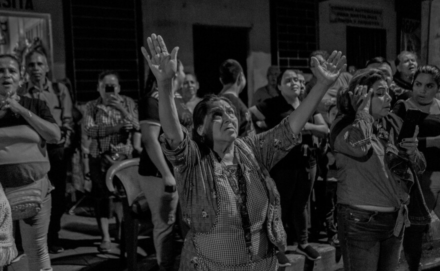 A mother cries and asks for mercy as she pleads for her son to be released from jail outside San Salvador's El Penalito jail on Oct. 12, 2022.