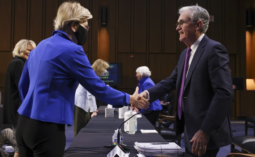 Sen. Elizabeth Warren, D-Mass., greets Powell before a Senate Banking, Housing and Urban Affairs Committee hearing on Sept. 28. Warren has been a strong critic of Powell, saying he has not been tough enough on banks.