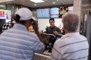 Lawrence Cheng, whose family owns seven Wendy's locations south of Los Angeles, takes orders from customers at his Wendy's restaurant in Fountain Valley on June 20, 2024.