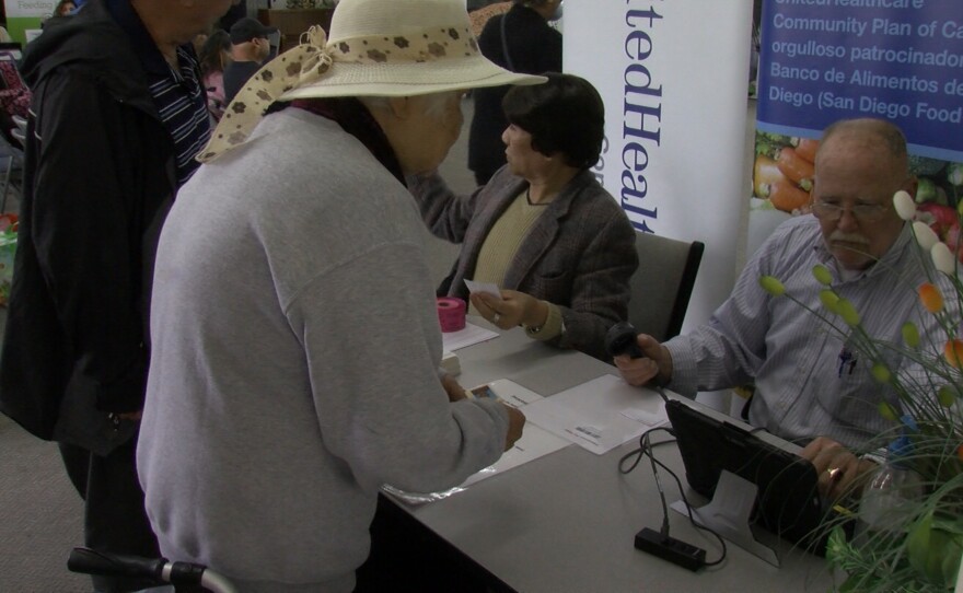A woman scans her card at the San Diego Food Bank, March 26, 2019.