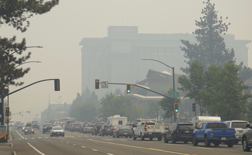 In this Aug. 30, 2021, file photo, vehicles idle in bumper-to-bumper traffic after a wildfire evacuation order in South Lake Tahoe, Calif. The threat the Caldor Fire poses to Lake Tahoe residents is exposing differences between laws against price-gouging in Nevada and California. 