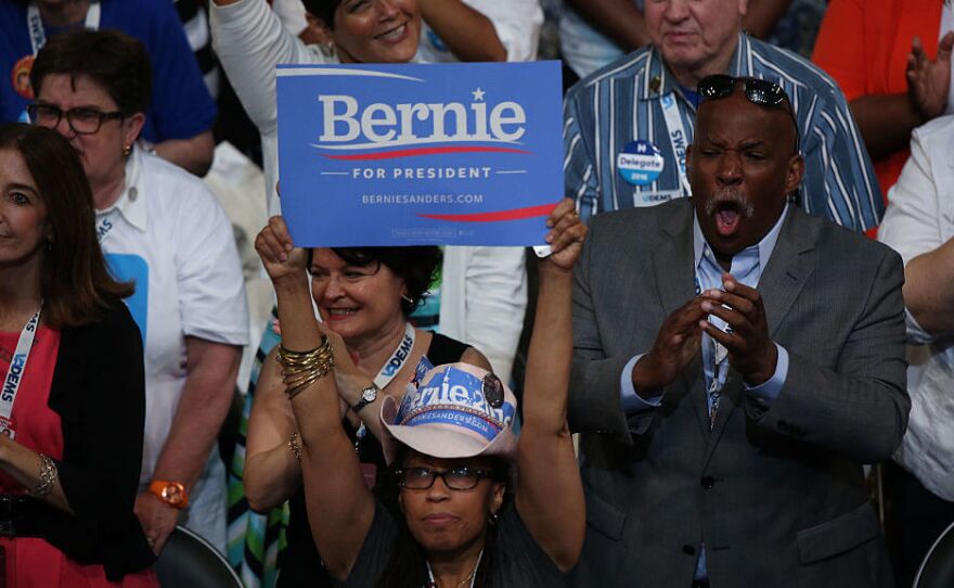 A delegate holds a campaign sign in support of Sen. Bernie Sanders, I-Vt., during the Democratic National Convention in Philadelphia.