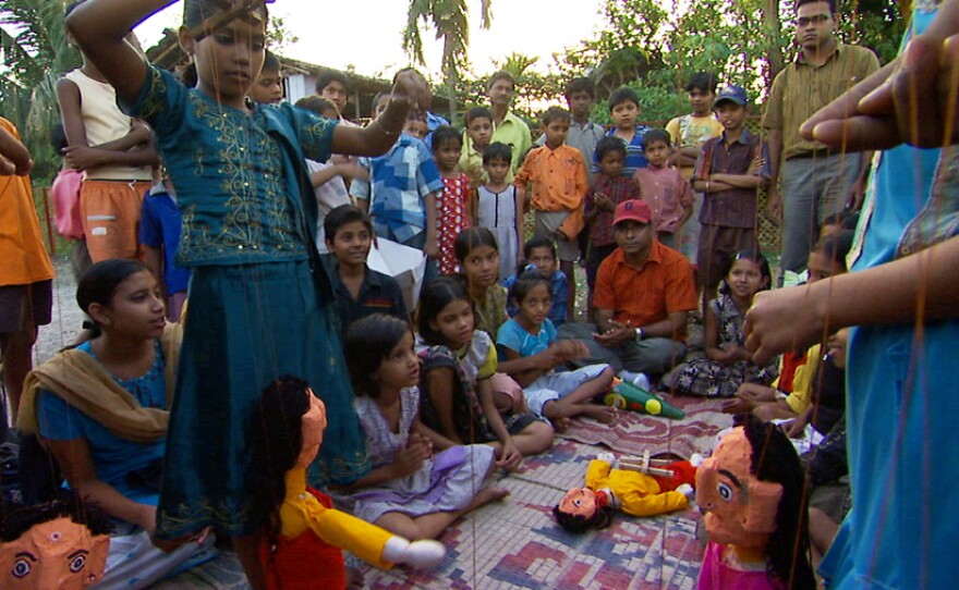 Amlan Ganguly and the children putting on a puppet show about the need for clean water in their neighborhood.