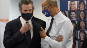 Gov. Gavin Newsom, left, speaks with Dr. Mark Ghaly, Secretary of the California Health and Human Services, at a news conference in Oakland, Calif., Monday, July 26, 2021.