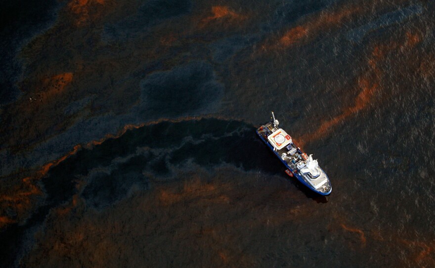 A boat travels through crude oil leaked from the Deepwater Horizon wellhead near Louisiana.