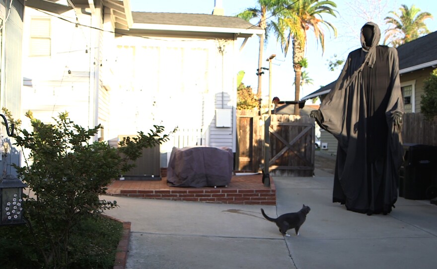 Andy Cameron poses as "Death" as part of a Halloween display on Maryland Street in San Diego's University Heights, Oct. 27, 2014.