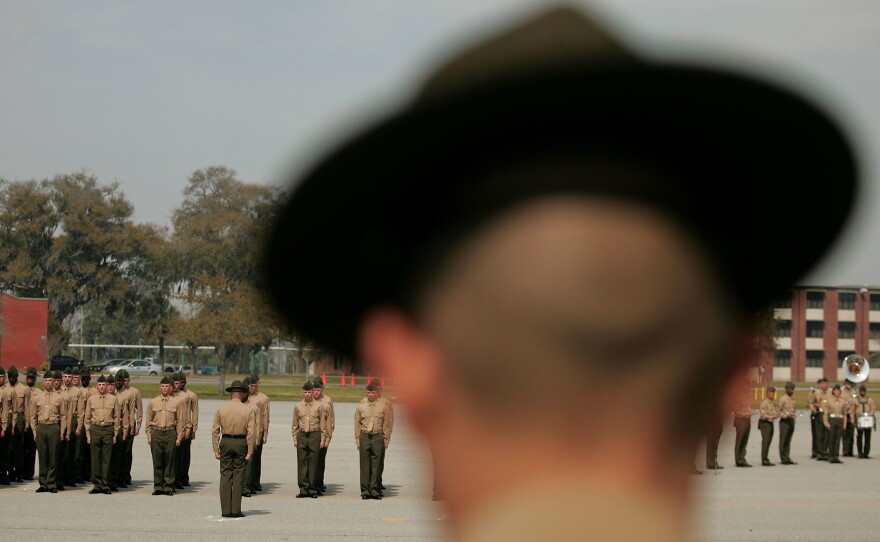 A Marine Corps drill instructor watches recruits on the parade deck during boot camp at Parris Island, S.C., in 2007.