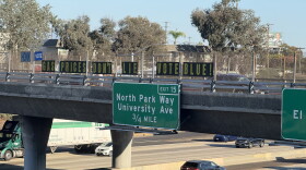 Letters spelling out the phrase, "Gas prices don't lie. Vote blue," are displayed on the Meade Avenue bridge over Interstate 805 on Oct. 8, 2026.