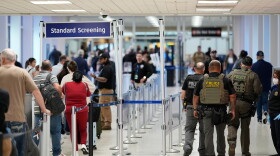 Federal immigration officers walk through a security checkpoint at George Bush Intercontinental Airport in Houston in March.