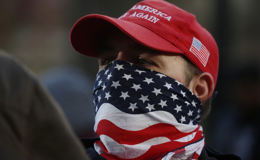 An attendee wears an American flag mask during the United Against Hate rally by the Washington Three Percent in Seattle last month.