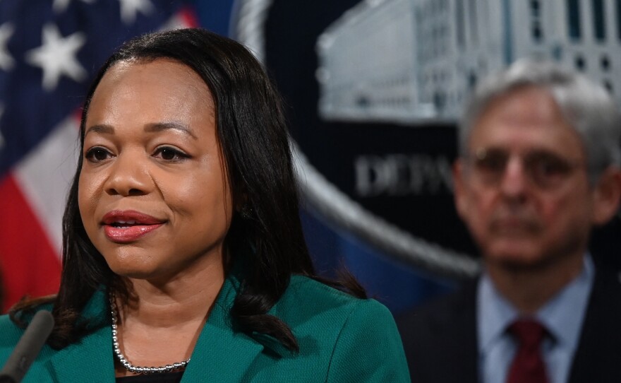 Assistant Attorney General Kristen Clarke for the Justice Department's Civil Rights Division speaks during a news conference Friday announcing a lawsuit against the state of Georgia for its new voting law. Attorney General Merrick Garland is at right.