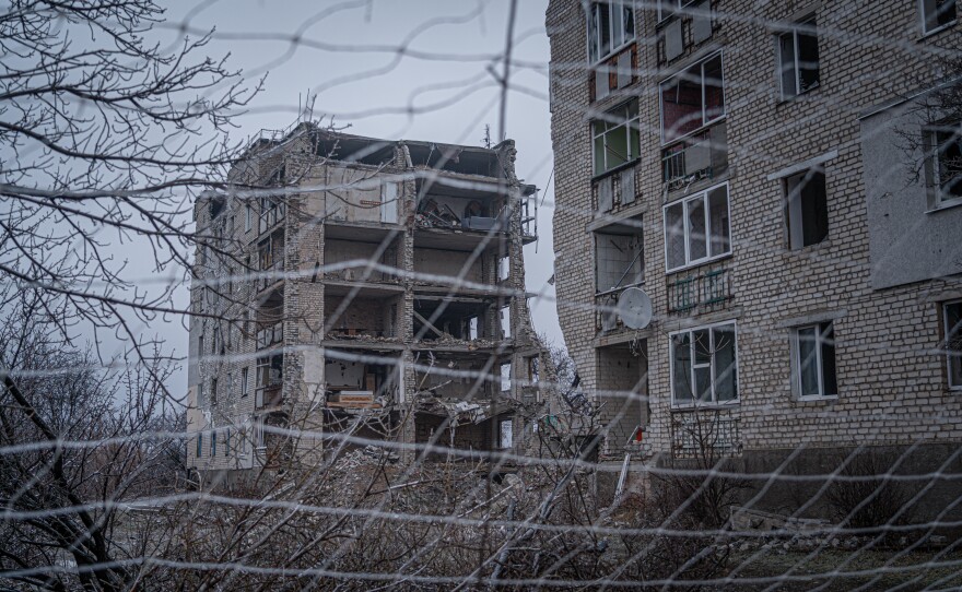 Nets line the city streets in Izium, Ukraine, in front of a building that's been destroyed by a Russian attack.