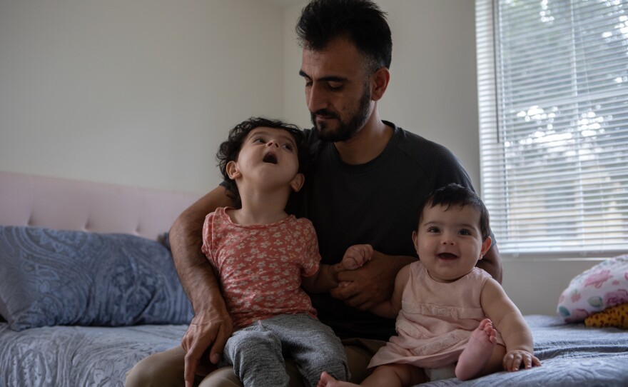 Shafiullah Amani and 3-year-old Yousra and 6-month-old Iqra, on Aug. 3, 2023.