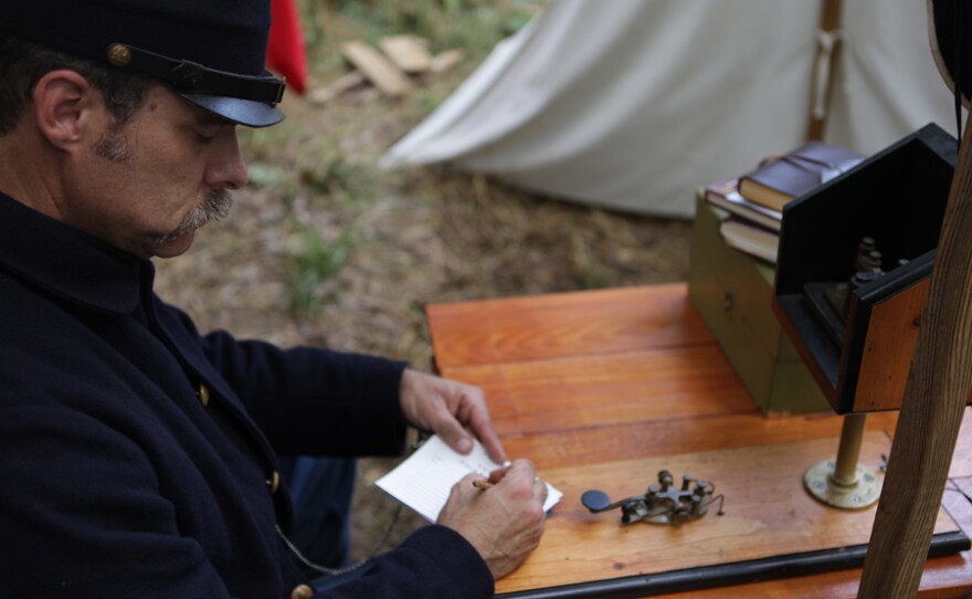 Reenactment of soldier using telegraph in the field in "Lincoln@Gettysburg."