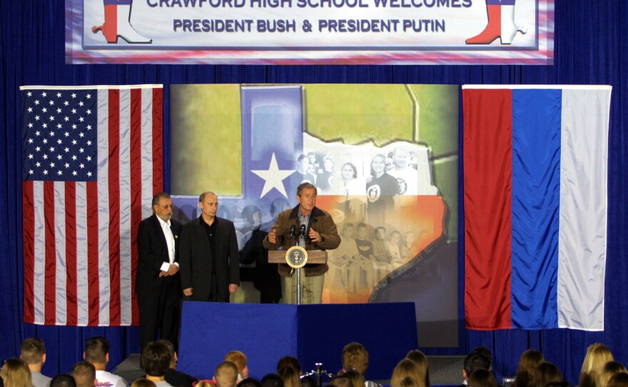 President George W. Bush and Russian President Vladimir Putin speak during a visit to Crawford High School in Crawford, Texas, on Nov. 15, 2001. The appearance wrapped up a summit of the newly elected presidents in Texas.
