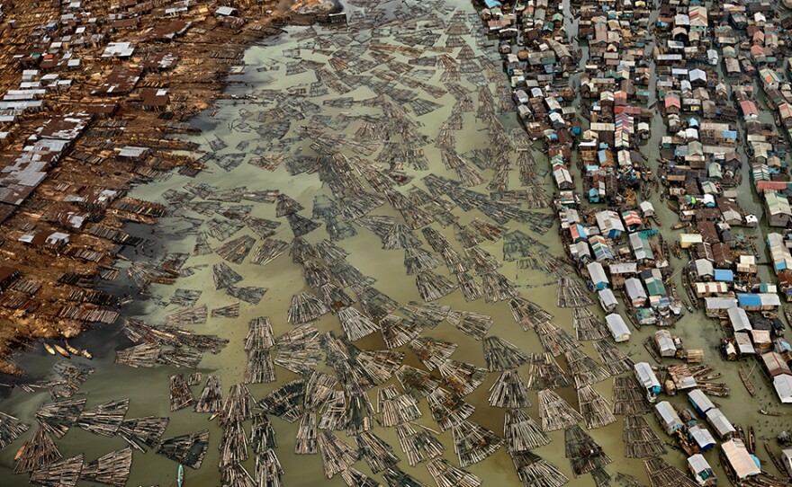 This aerial photo depicts the sawmills of Lagos, Nigeria. The timber from the country's rainforests, some of the most heavily deforested in the world, are processed in this coastal city, polluting the lagoons.