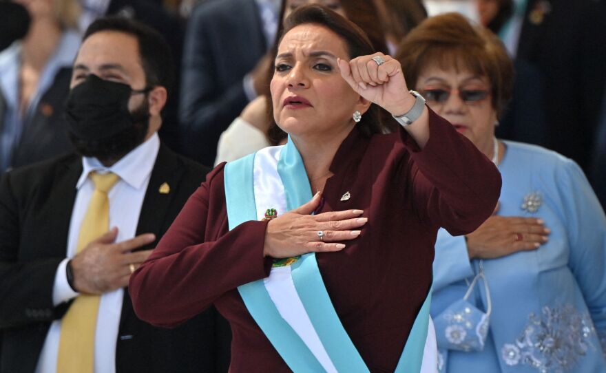 Honduran President Xiomara Castro holds up her fist after being sworn in during her inauguration ceremony in Tegucigalpa.