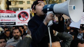 An Egyptian boy wields a megaphone as he chants anti-government slogans in Cairo's Tahrir Square on Monday afternoon.