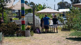 Danny Kaffer, one of the caregivers of Mt. Hope Community Garden, greets a visitor in the garden.